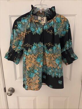 FIGUE: top with smocking at neck and sleeve. Black with blue tan print cotton